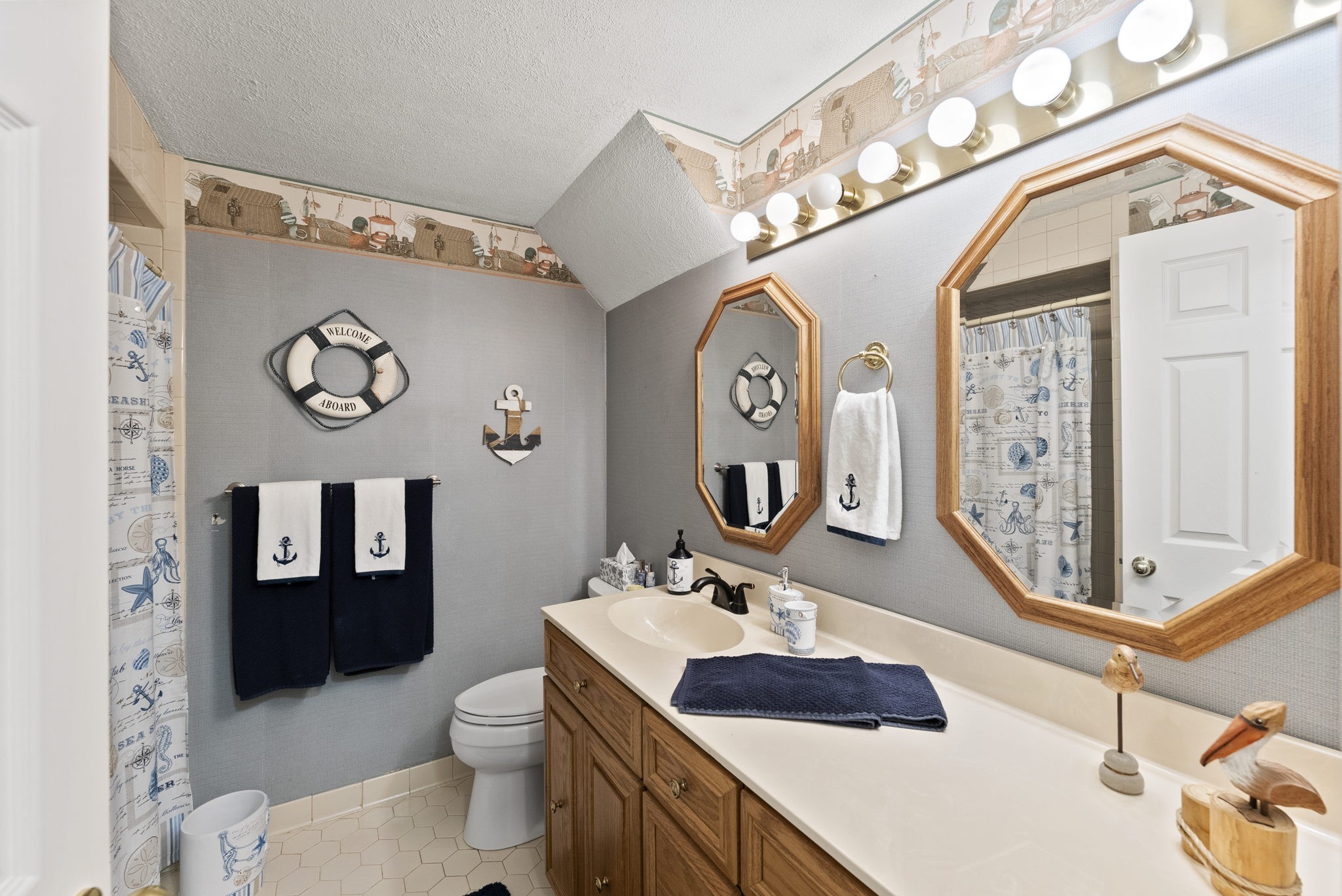 812 Burton Point Road Mount Juliet, TN 37122 - Photo 34 of 59 a bathroom with a toilet a sink and mirror