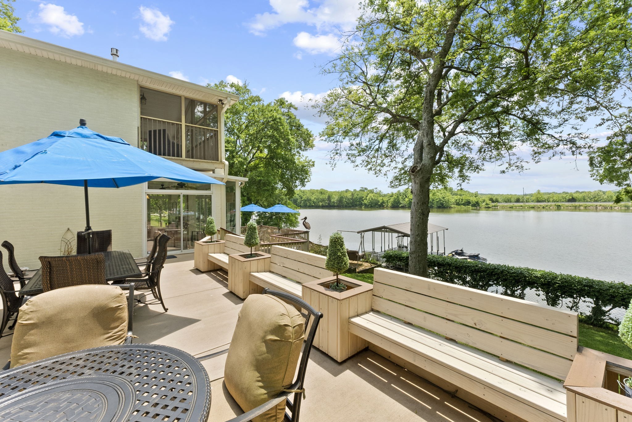 812 Burton Point Road Mount Juliet, TN 37122 - Photo 39 of 59 a view of a patio with couches chairs and an umbrella