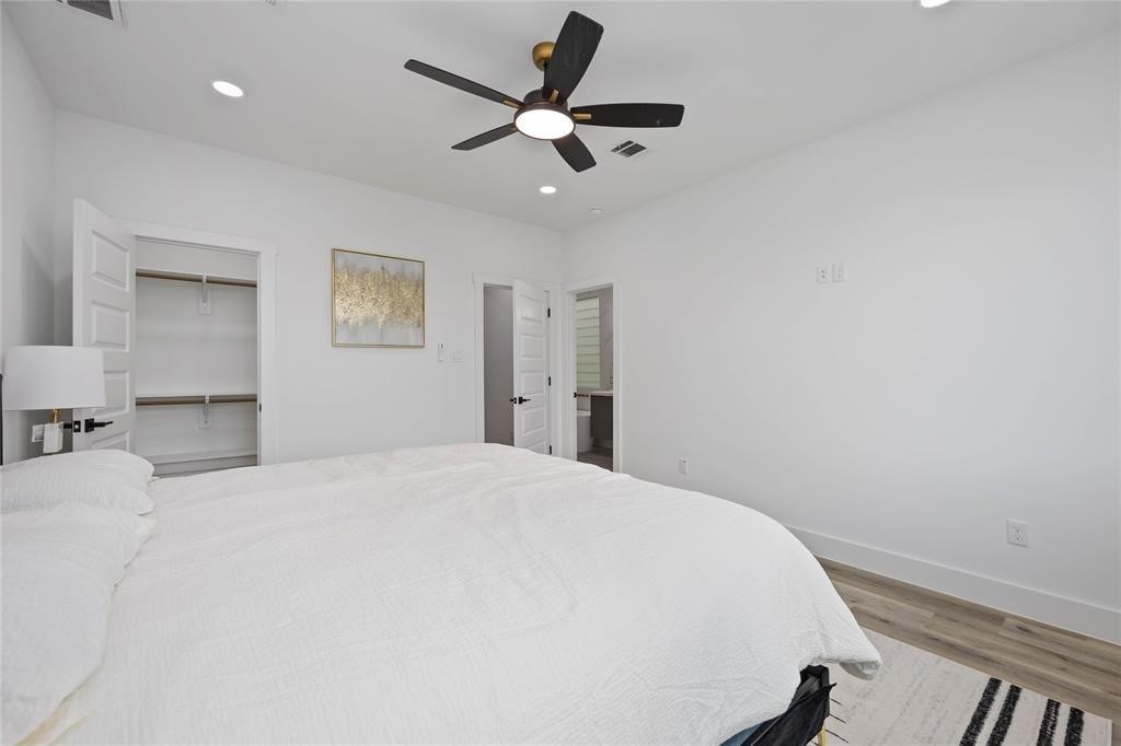 1805 Emir Street, Unit L Houston, TX 77009 - Photo 15 of 35 The door to the right leads to a luxurious ensuite bathroom. Featured here is one of two closets in the home. The other walk-in closet is in the primary bath.