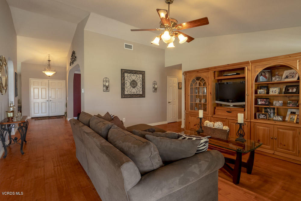1795 Rambling Road Simi Valley, CA 93065 - Photo 11 of 60 a living room with furniture flat screen tv and a chandelier