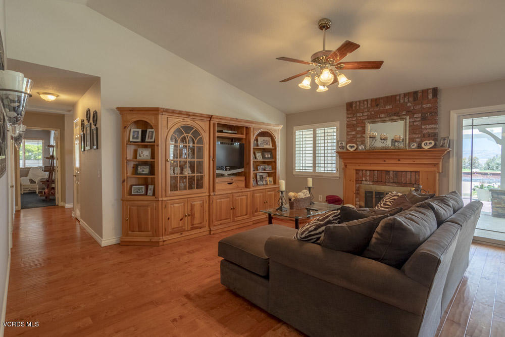 1795 Rambling Road Simi Valley, CA 93065 - Photo 12 of 60 a living room with furniture a chandelier and a fireplace