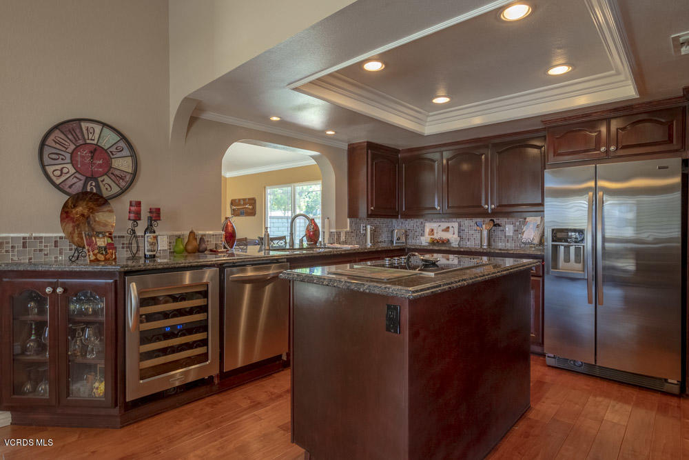 1795 Rambling Road Simi Valley, CA 93065 - Photo 14 of 60 a kitchen with kitchen island granite countertop a stove and a refrigerator