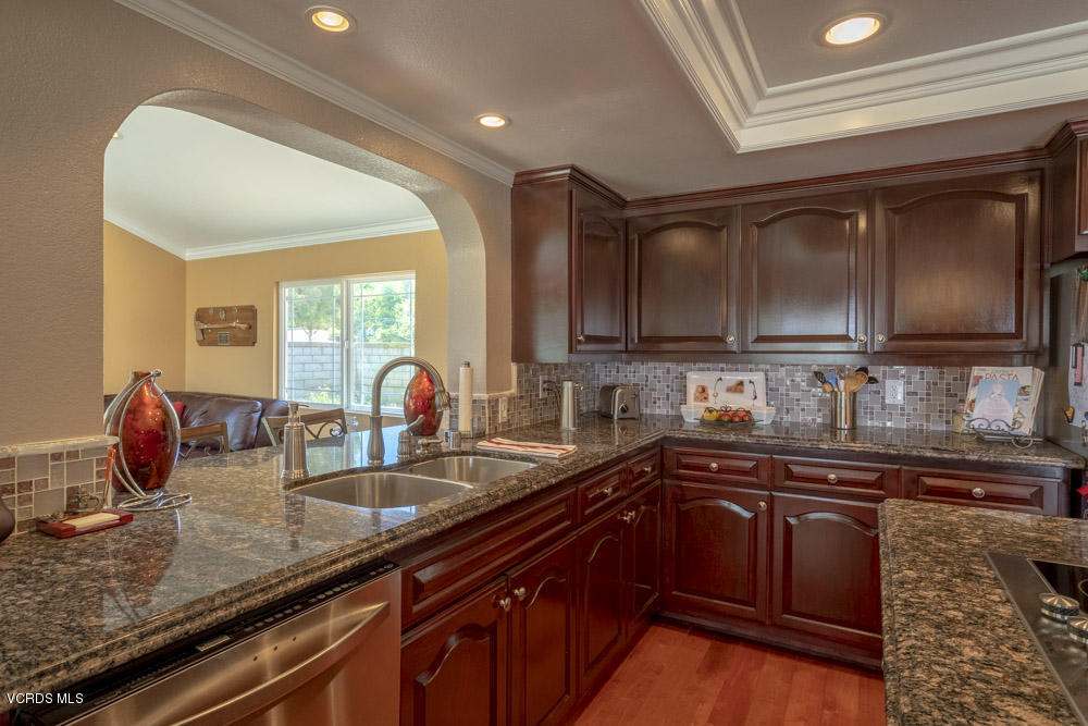 1795 Rambling Road Simi Valley, CA 93065 - Photo 16 of 60 a kitchen with granite countertop a sink stainless steel appliances and cabinets