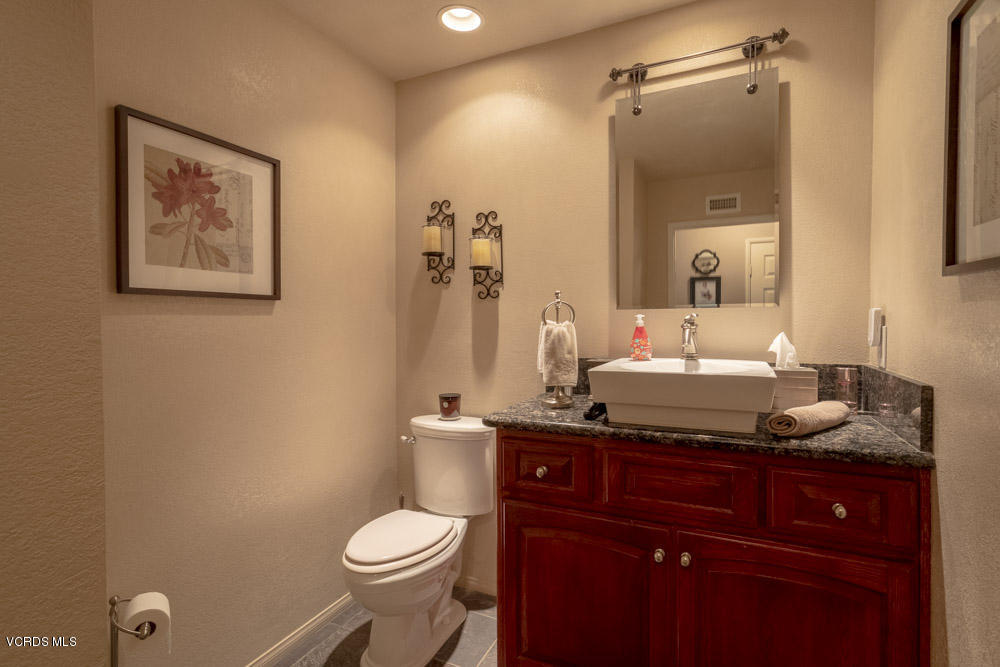 1795 Rambling Road Simi Valley, CA 93065 - Photo 24 of 60 a bathroom with a granite countertop toilet sink and mirror