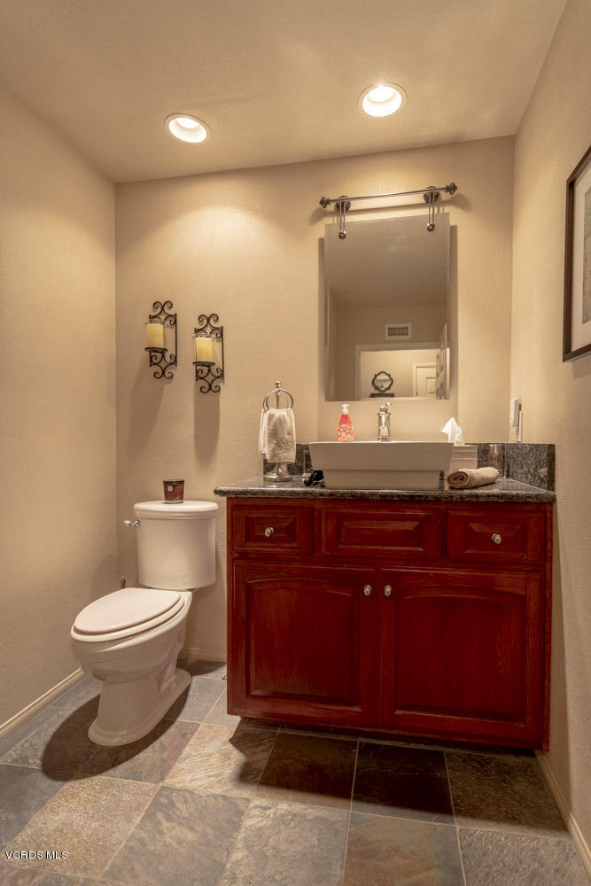 1795 Rambling Road Simi Valley, CA 93065 - Photo 25 of 60 a bathroom with a granite countertop sink and a mirror