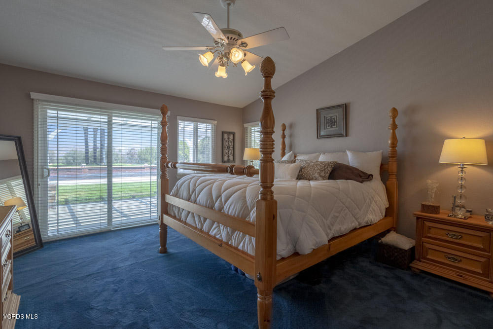 1795 Rambling Road Simi Valley, CA 93065 - Photo 28 of 60 a spacious bedroom with a bed and a chandelier