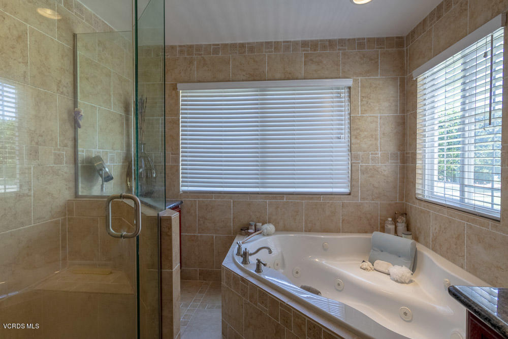 1795 Rambling Road Simi Valley, CA 93065 - Photo 32 of 60 a bath tub sitting in a bathroom next to a window