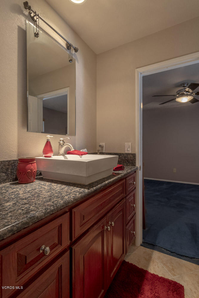 1795 Rambling Road Simi Valley, CA 93065 - Photo 34 of 60 a bathroom with a granite countertop sink and a mirror