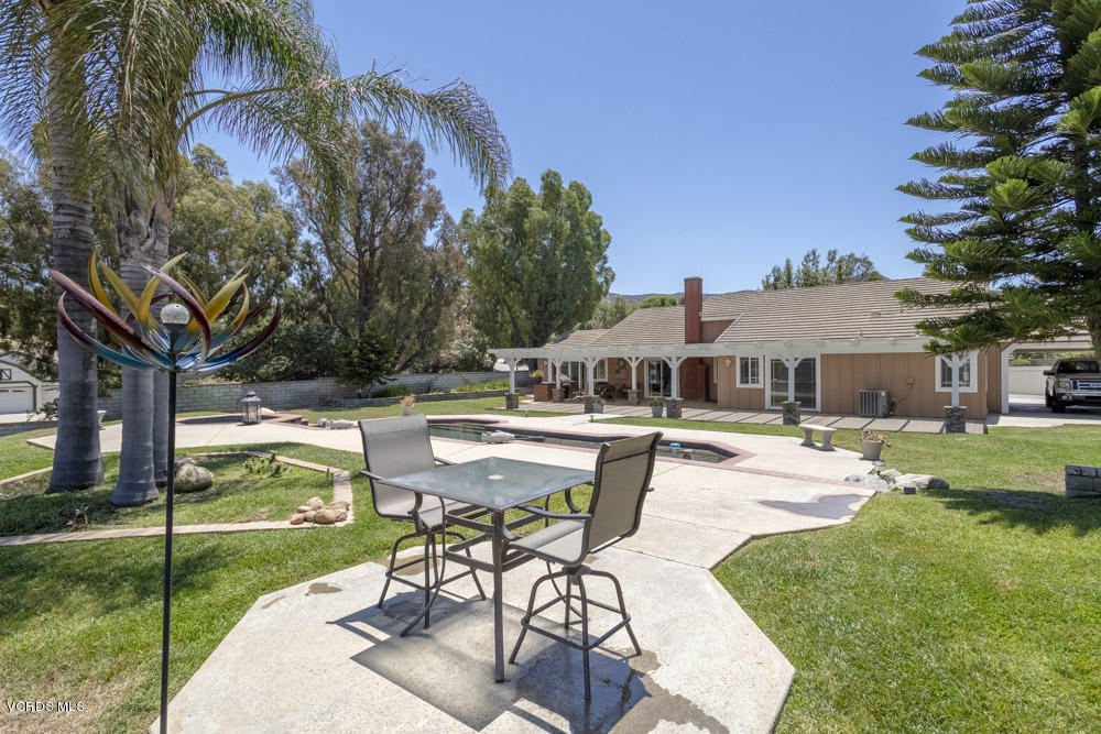 1795 Rambling Road Simi Valley, CA 93065 - Photo 46 of 60 a view of a patio with table and chairs under an umbrella
