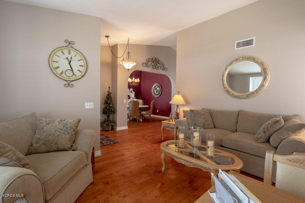 1795 Rambling Road Simi Valley, CA 93065 - Photo 7 of 60 a living room with furniture a rug and a wall painting
