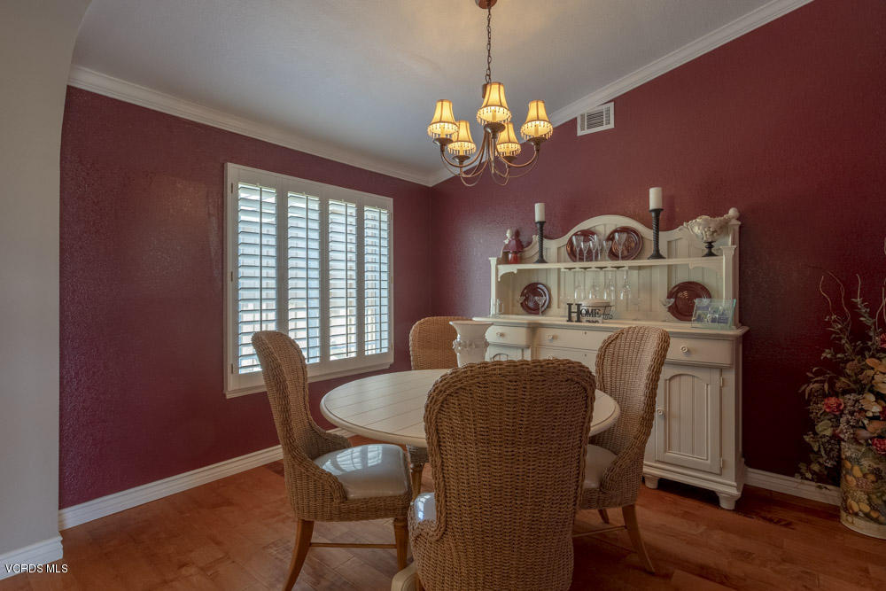 1795 Rambling Road Simi Valley, CA 93065 - Photo 8 of 60 a dining room with furniture a chandelier and wooden floor