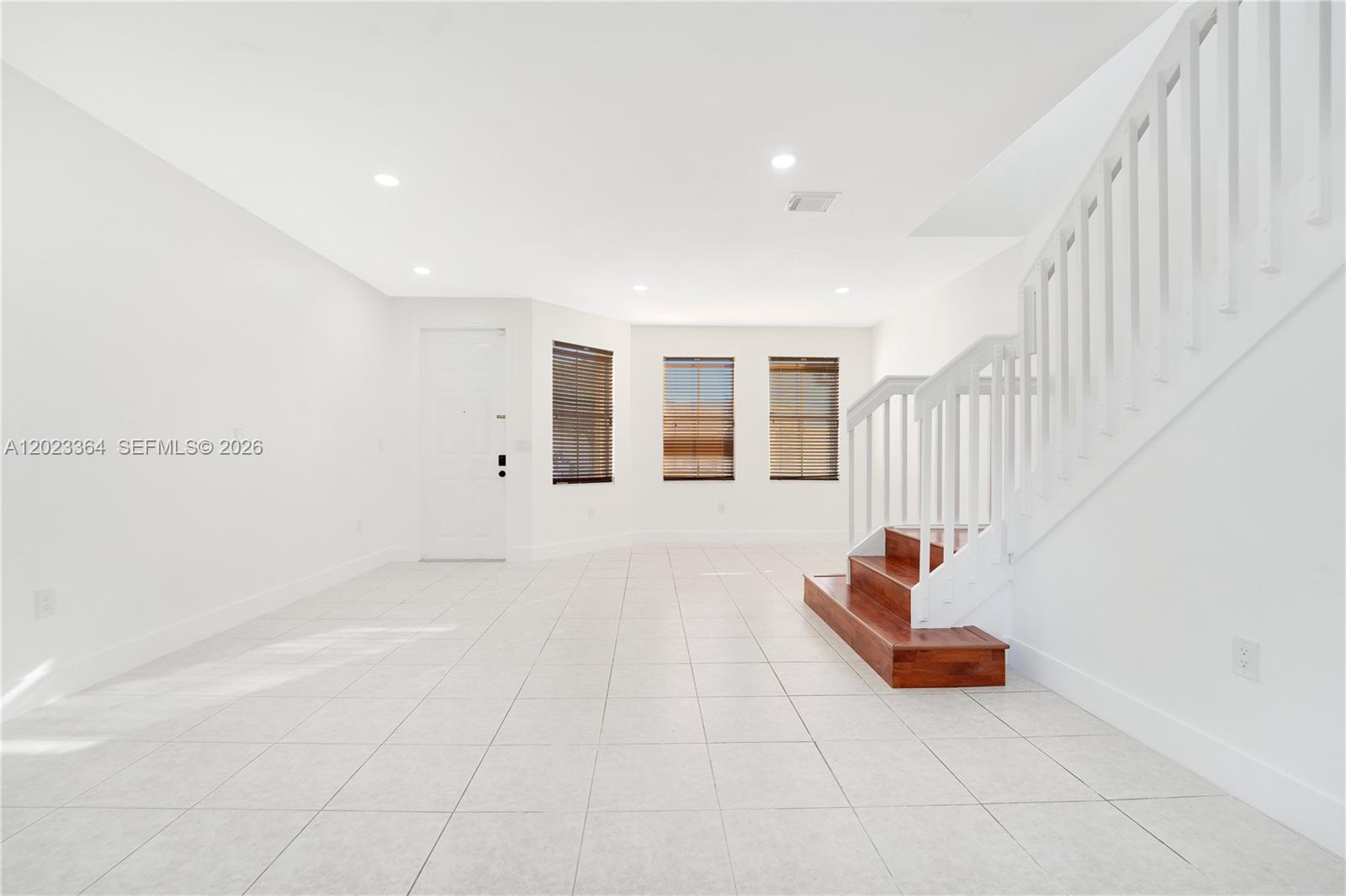 27433 Southwest 137th Court, Unit 1 Homestead, FL 33032 - Photo 5 of 28 a view of an empty room with stairs and a window