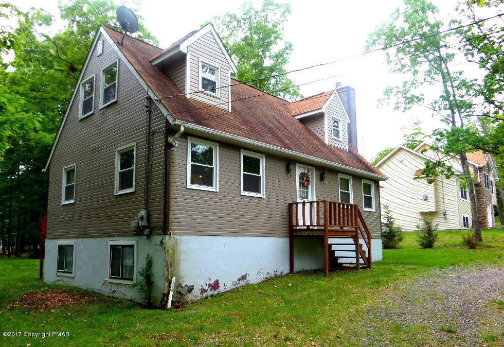 113 Lehman Road Bushkill, PA 18324 - Photo 3 of 23 a front view of a house with a garden and deck