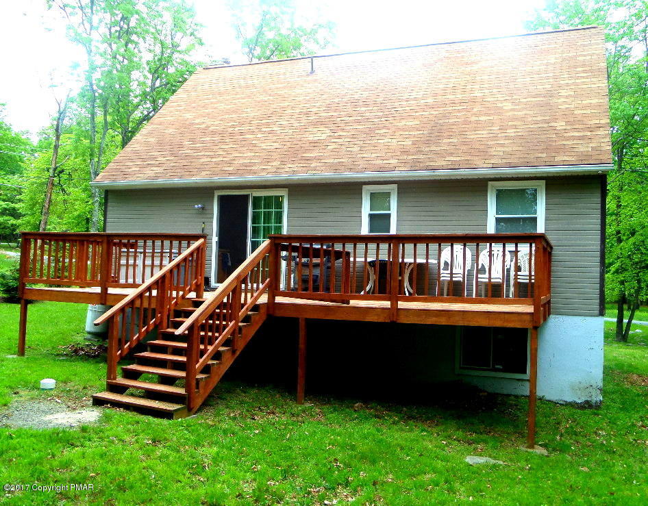 113 Lehman Road Bushkill, PA 18324 - Photo 4 of 23 an outdoor view of house with swimming pool and deck