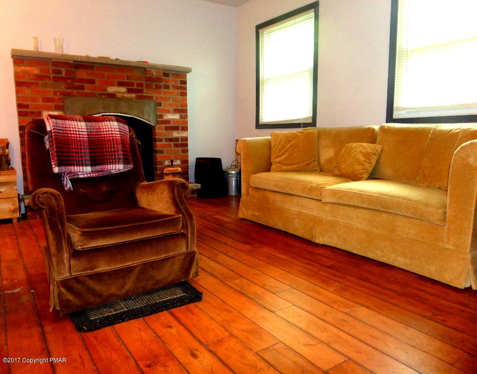 113 Lehman Road Bushkill, PA 18324 - Photo 10 of 23 a living room with furniture and a fireplace