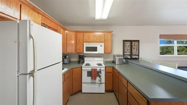 a kitchen with a refrigerator stove and sink