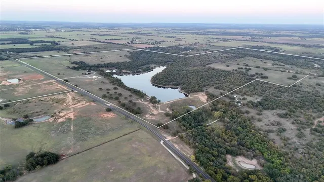 view of a lake with houses in the back