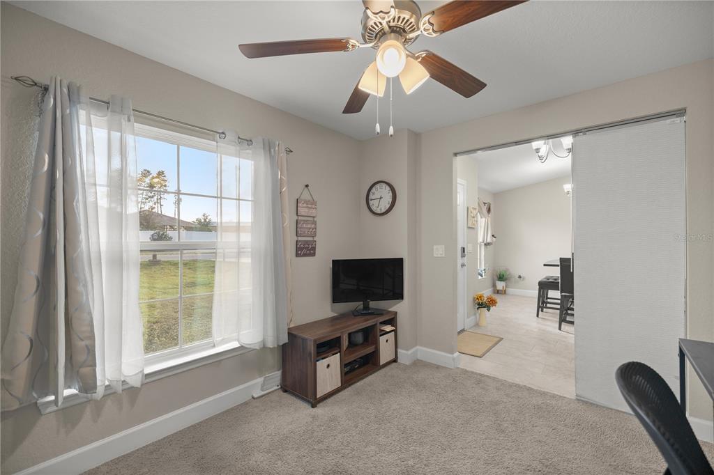 9609 Southwest 40th Terrace Ocala, FL 34476 - Photo 13 of 28 a living room with furniture and a flat screen tv