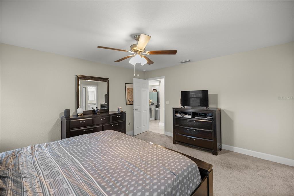 9609 Southwest 40th Terrace Ocala, FL 34476 - Photo 16 of 28 a bedroom with a bed and a television