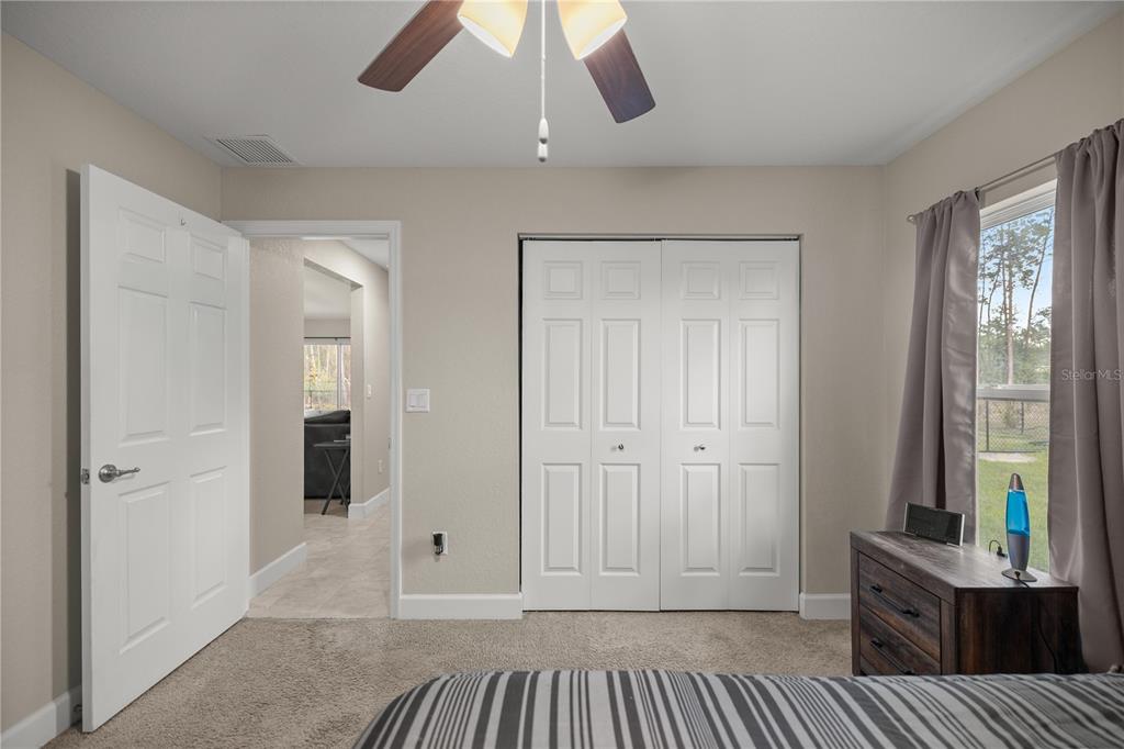 9609 Southwest 40th Terrace Ocala, FL 34476 - Photo 20 of 28 a spacious bedroom with a bed and a window