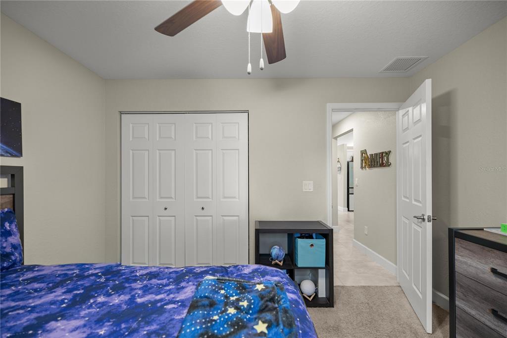 9609 Southwest 40th Terrace Ocala, FL 34476 - Photo 22 of 28 a bedroom with a bed and a table