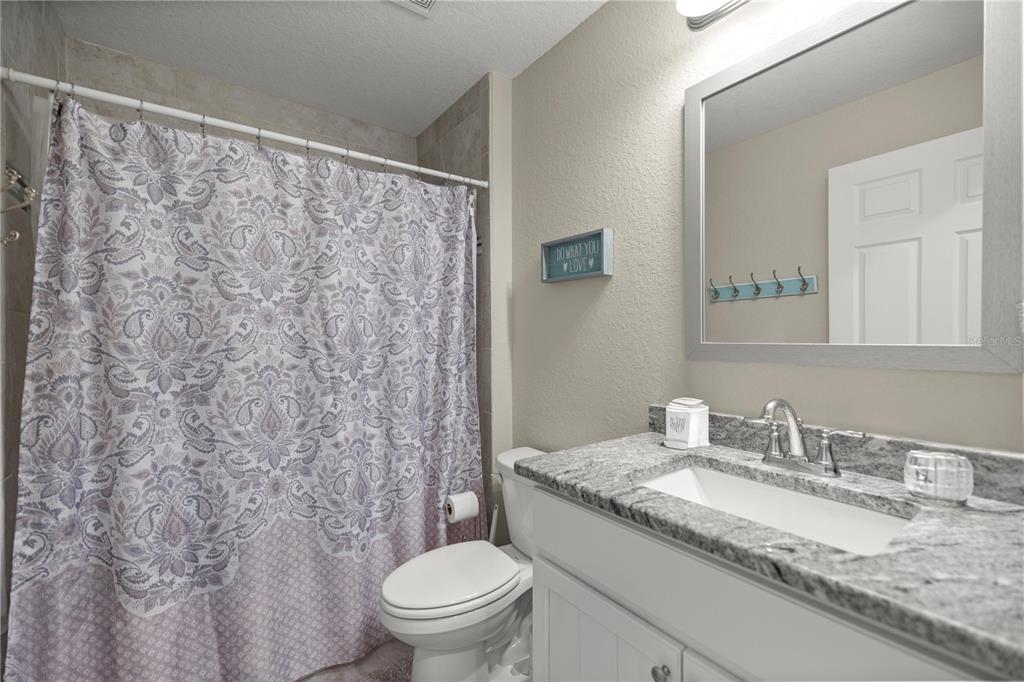 9609 Southwest 40th Terrace Ocala, FL 34476 - Photo 23 of 28 a bathroom with a granite countertop sink and a mirror