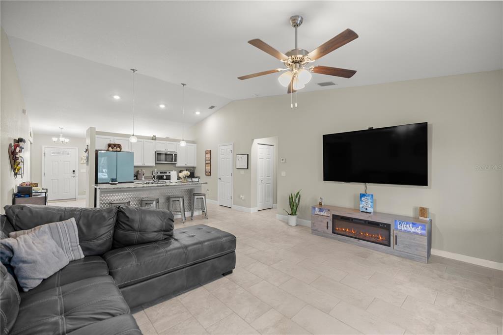 9609 Southwest 40th Terrace Ocala, FL 34476 - Photo 6 of 28 a living room with furniture and a flat screen tv