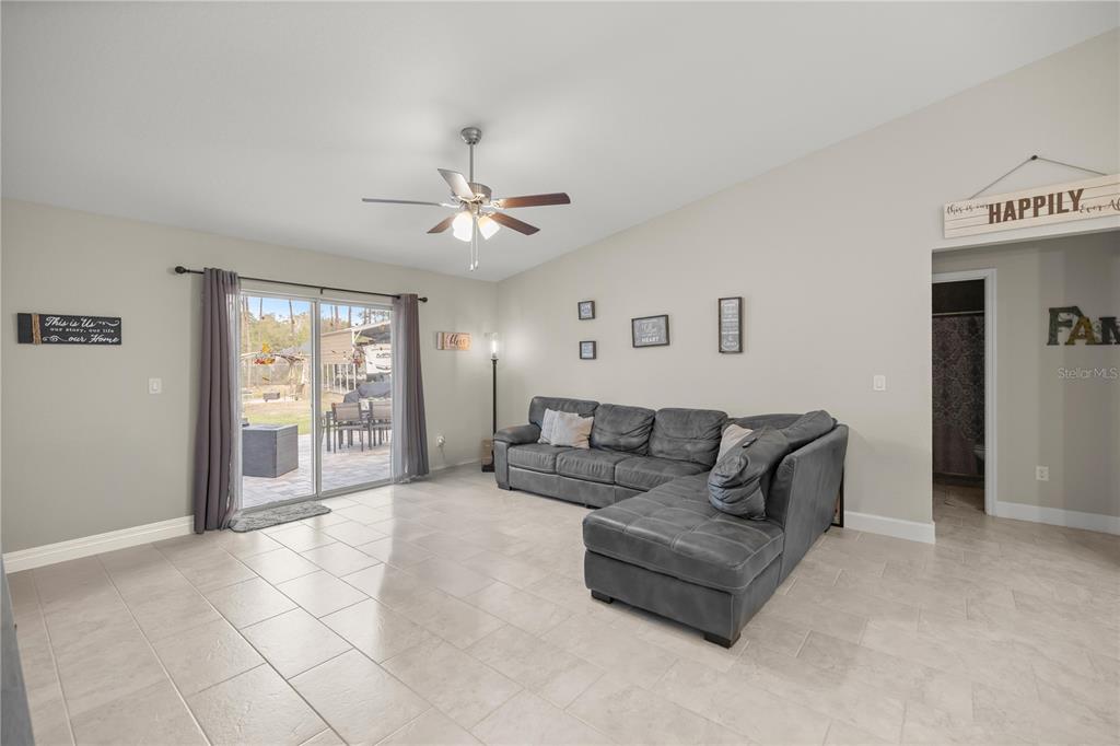 9609 Southwest 40th Terrace Ocala, FL 34476 - Photo 7 of 28 a living room with furniture and a large window