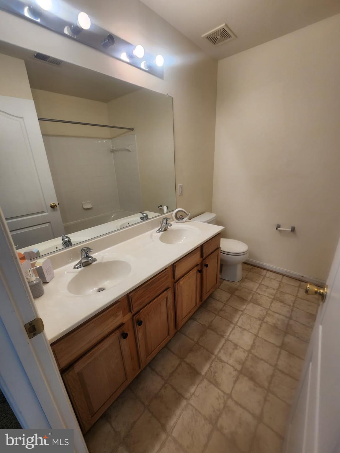 10208 Rolling Green Way Fort Washington, MD 20744 - Photo 12 of 14 a bathroom with a sink double vanity and a mirror