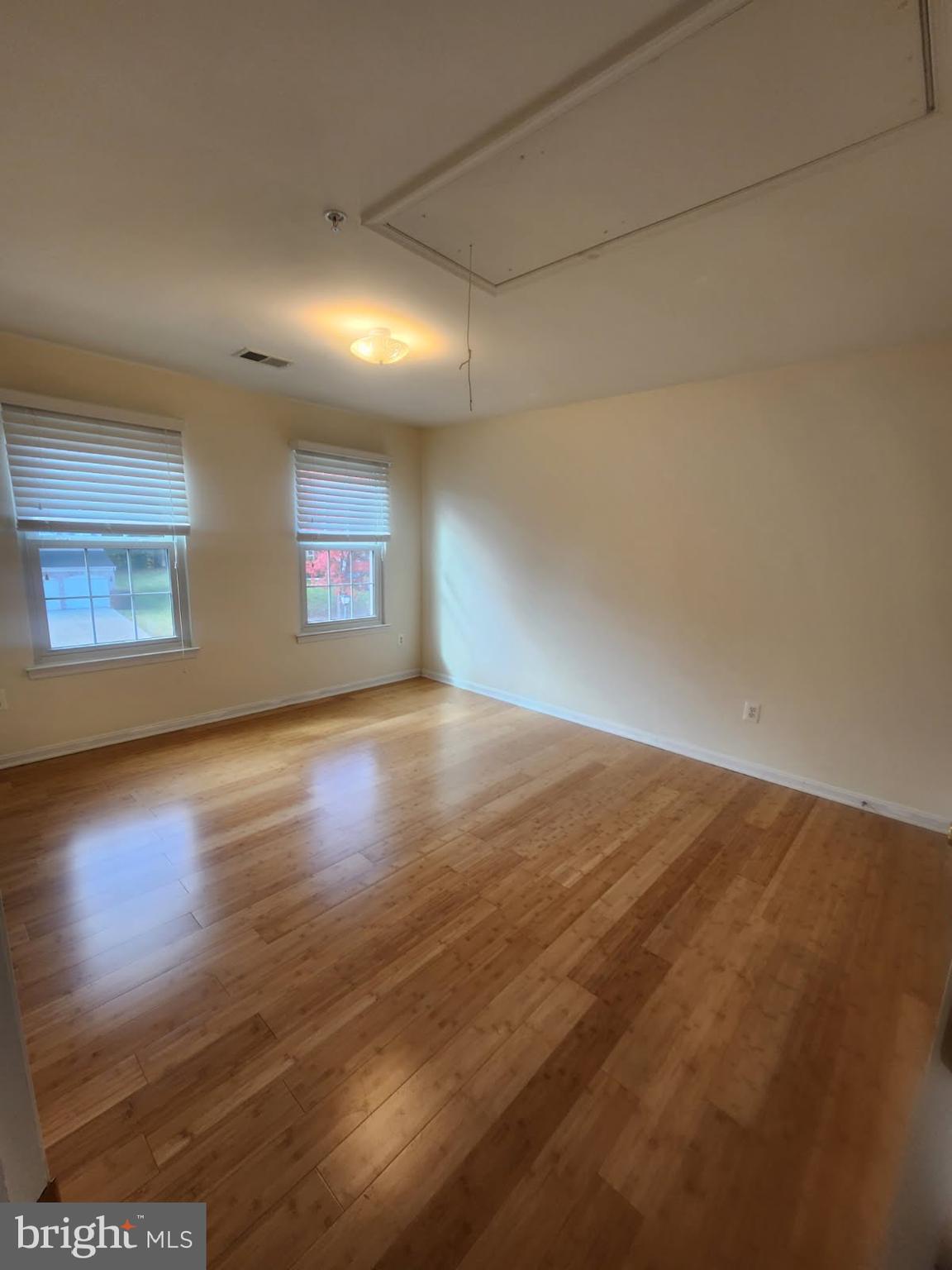 10208 Rolling Green Way Fort Washington, MD 20744 - Photo 14 of 14 an empty room with wooden floor and windows