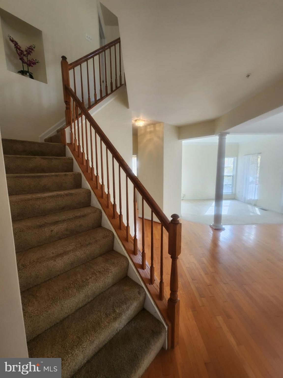 10208 Rolling Green Way Fort Washington, MD 20744 - Photo 2 of 14 a view of staircase with lots of frames on wall and wooden floor