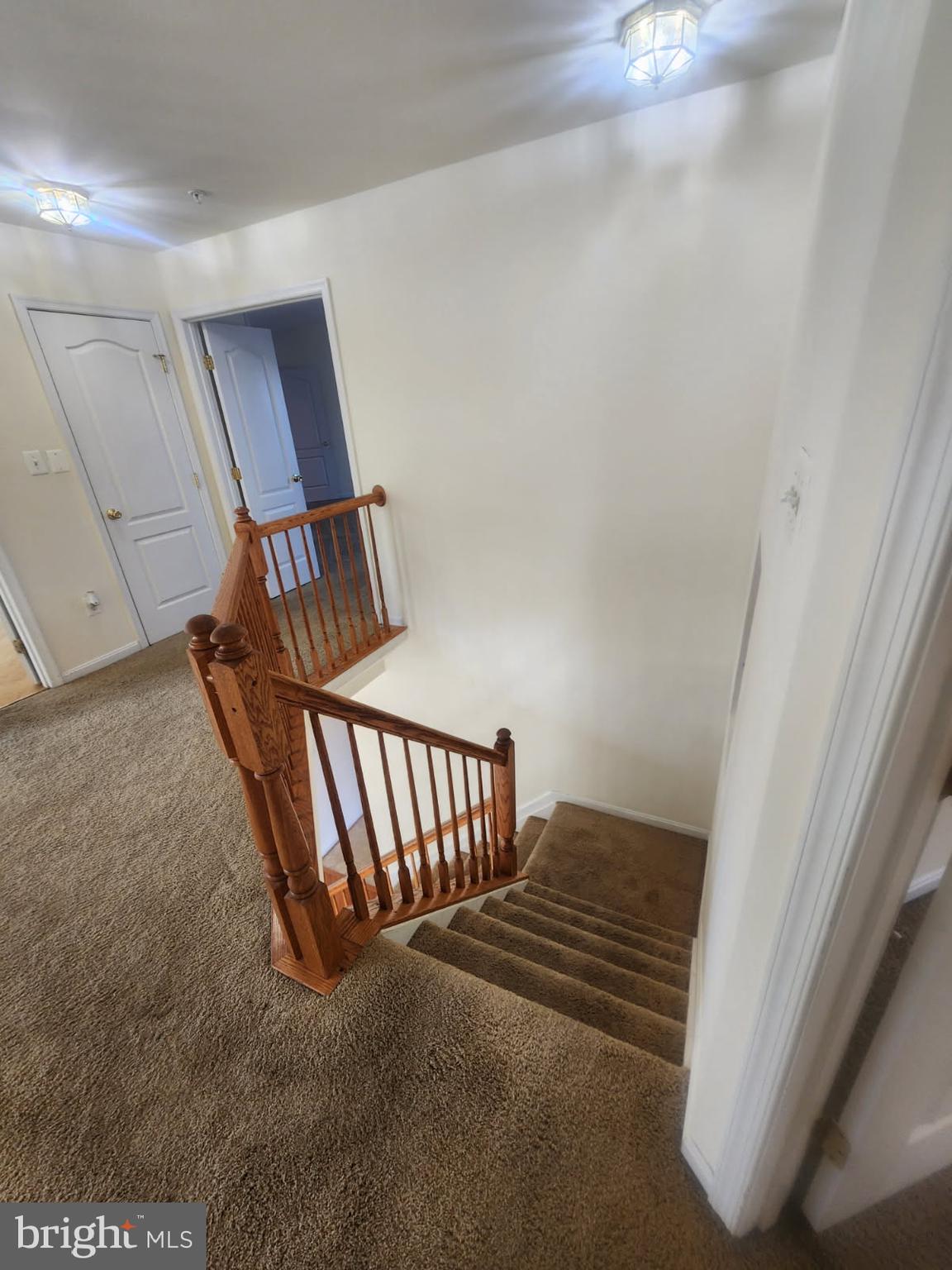 10208 Rolling Green Way Fort Washington, MD 20744 - Photo 8 of 14 a view of staircase with white walls and railing