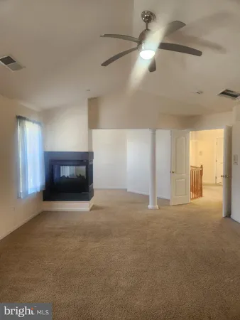a view of empty room with a fireplace