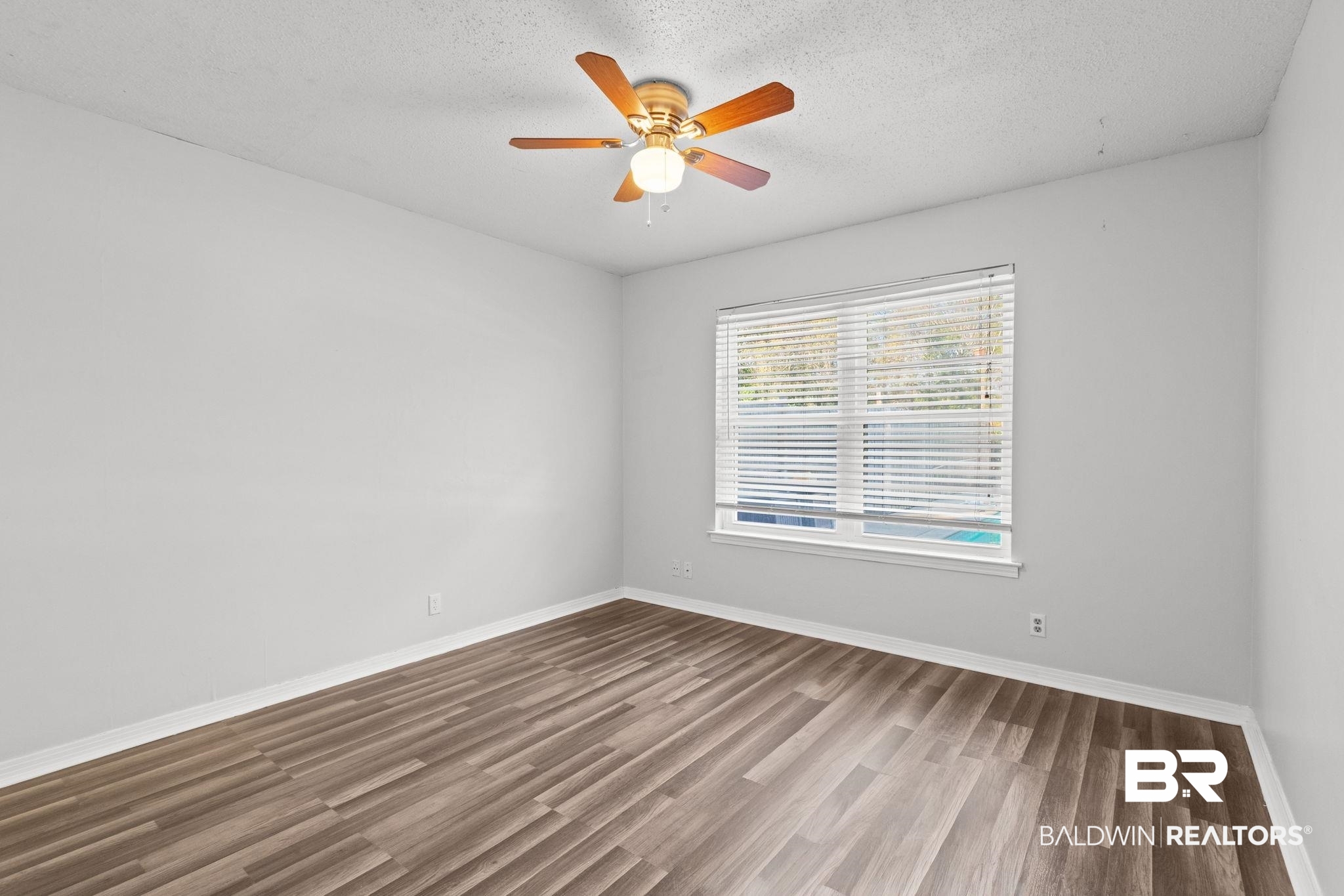 3864 Leroy Stevens Road Mobile, AL 36619 - Photo 22 of 33 Unfurnished room featuring wood finished floors, ceiling fan, and a textured ceiling