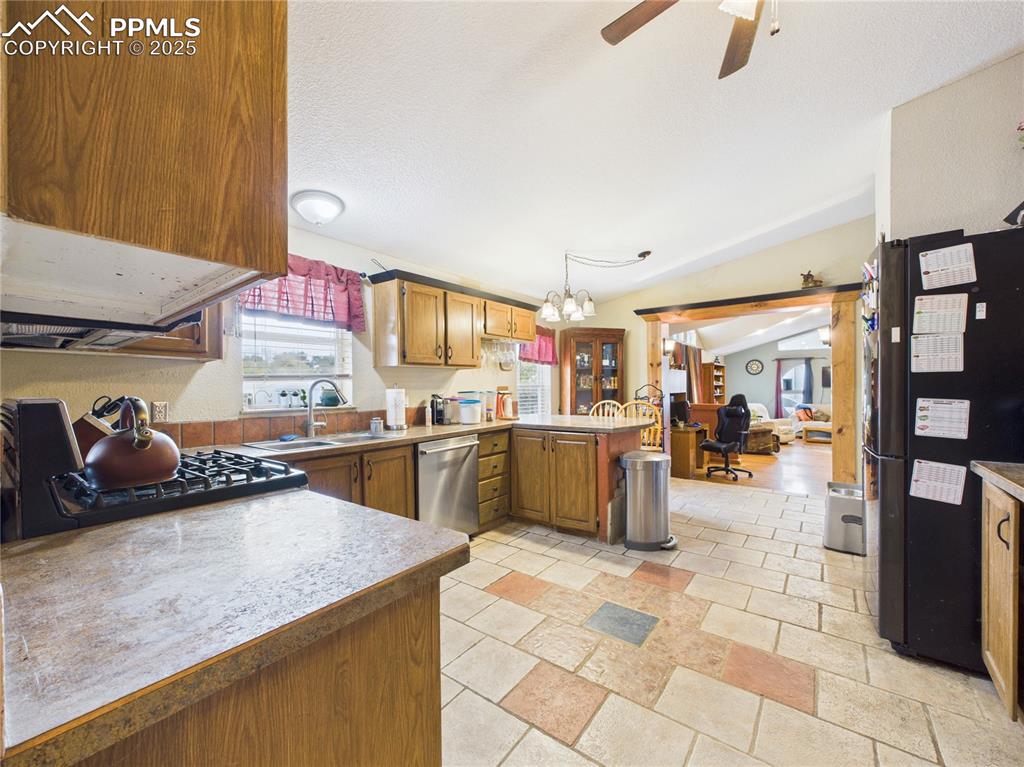206 Lucille Street Avondale, CO 81022 - Photo 14 of 36 a kitchen with lots of counter top space and appliances