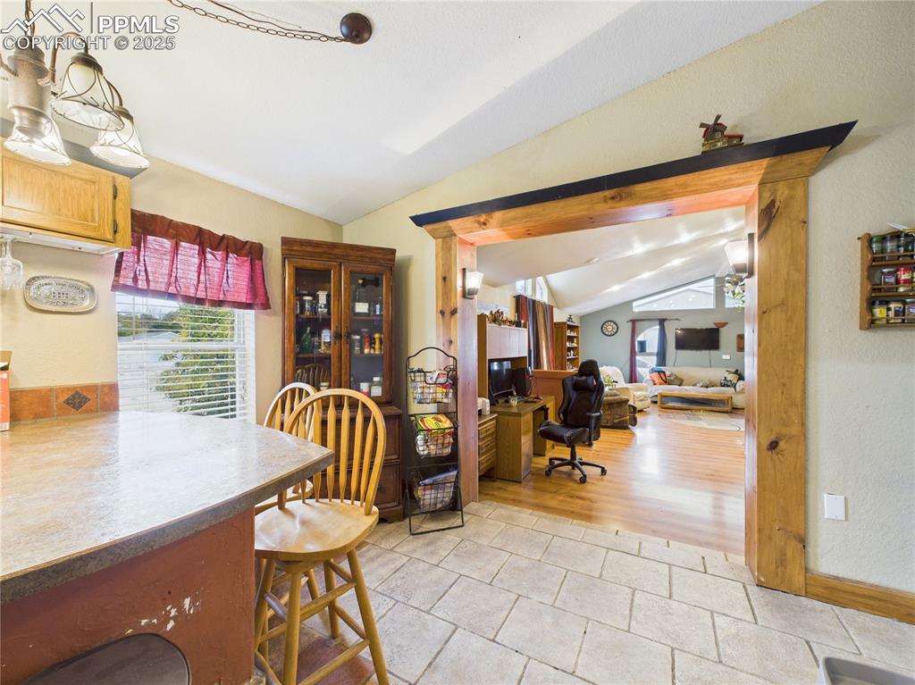 206 Lucille Street Avondale, CO 81022 - Photo 18 of 36 a living room filled with furniture and a chandelier