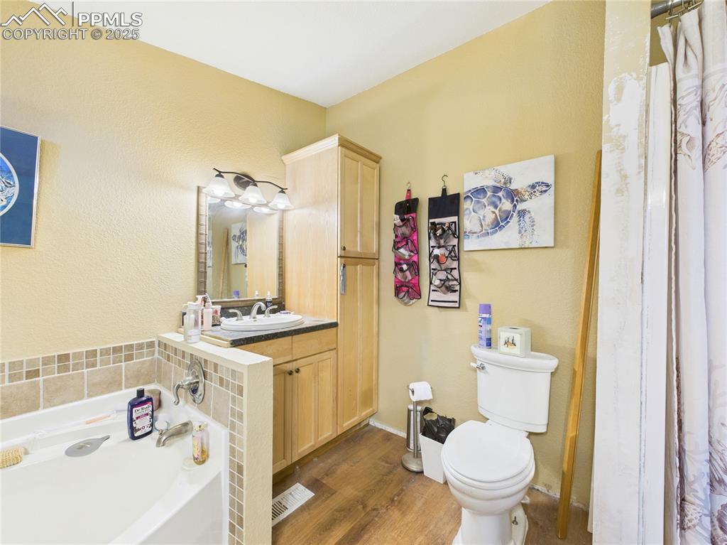 206 Lucille Street Avondale, CO 81022 - Photo 24 of 36 a bathroom with a sink toilet vanity and tub