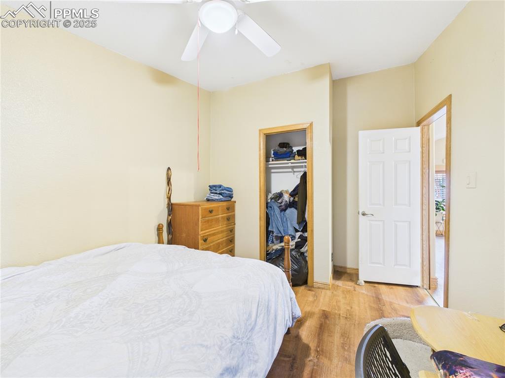 206 Lucille Street Avondale, CO 81022 - Photo 30 of 36 a bedroom with a bed and a chandelier