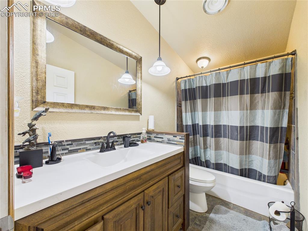 206 Lucille Street Avondale, CO 81022 - Photo 31 of 36 a bathroom with a sink a toilet a mirror and shower