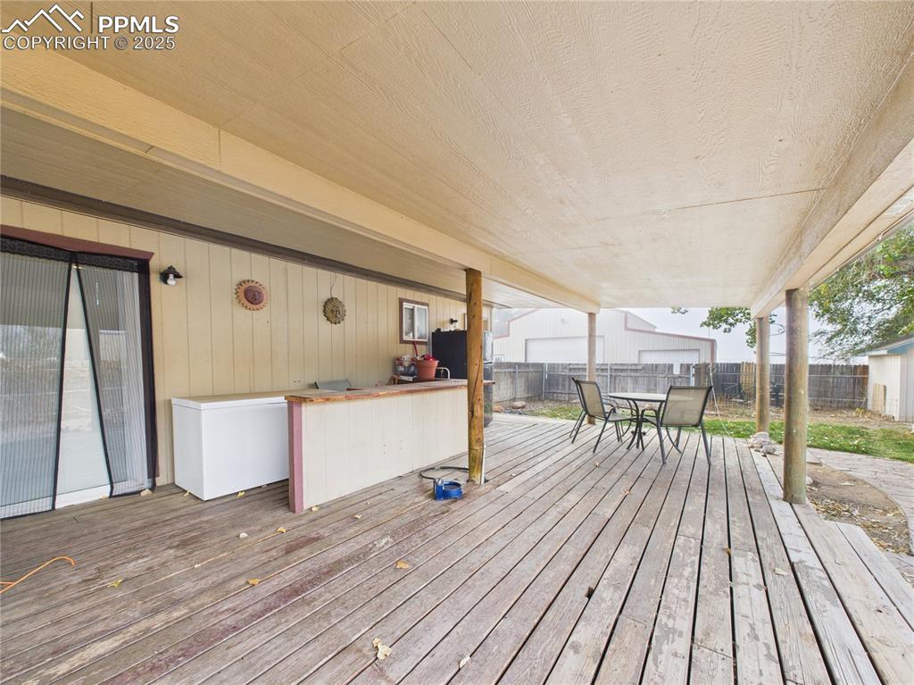 206 Lucille Street Avondale, CO 81022 - Photo 32 of 36 a room with wooden floor and furniture