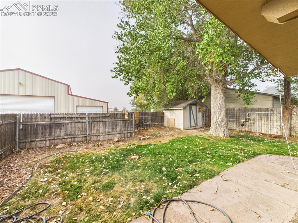 206 Lucille Street Avondale, CO 81022 - Photo 35 of 36 a garden with trees in front of it