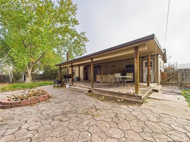a view of a house with backyard and sitting area