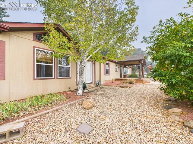 a front view of a house with a yard and a garden