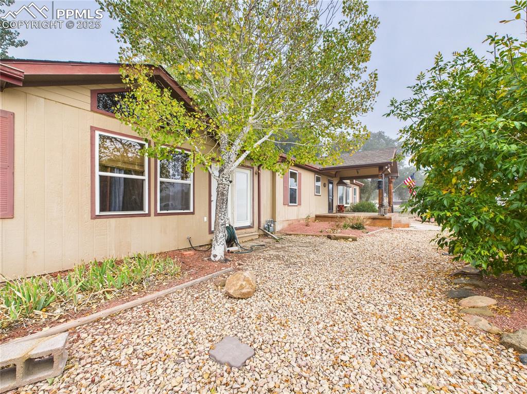 206 Lucille Street Avondale, CO 81022 - Photo 5 of 36 a front view of a house with a yard and a garden