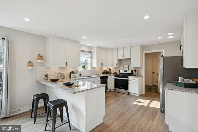 a kitchen with a sink cabinets and wooden floor