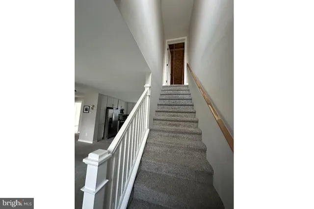 a view of a hallway with stairs