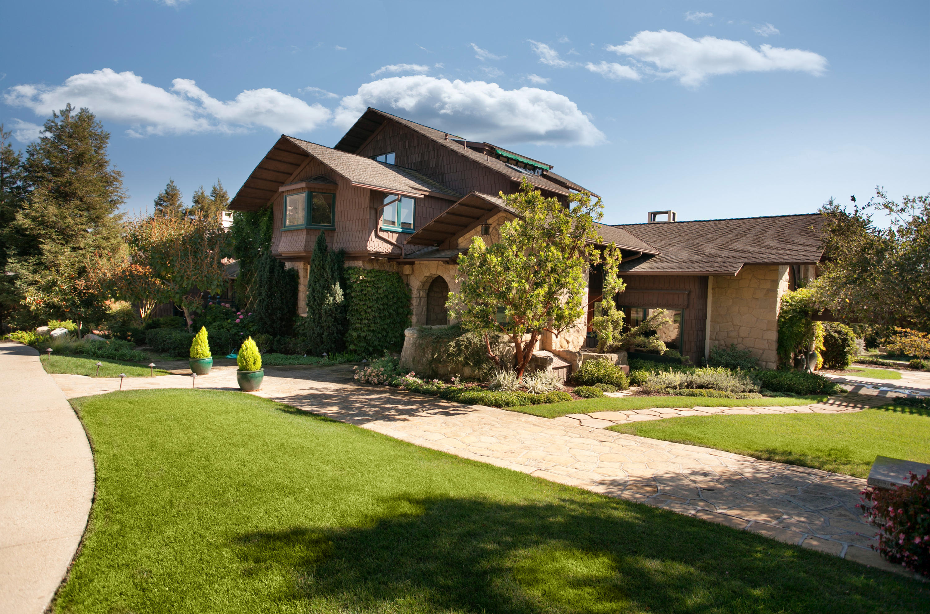 699 San Ysidro Road Montecito, CA 93108 - Photo 20 of 36 a view of a house with entertaining space and a small yard