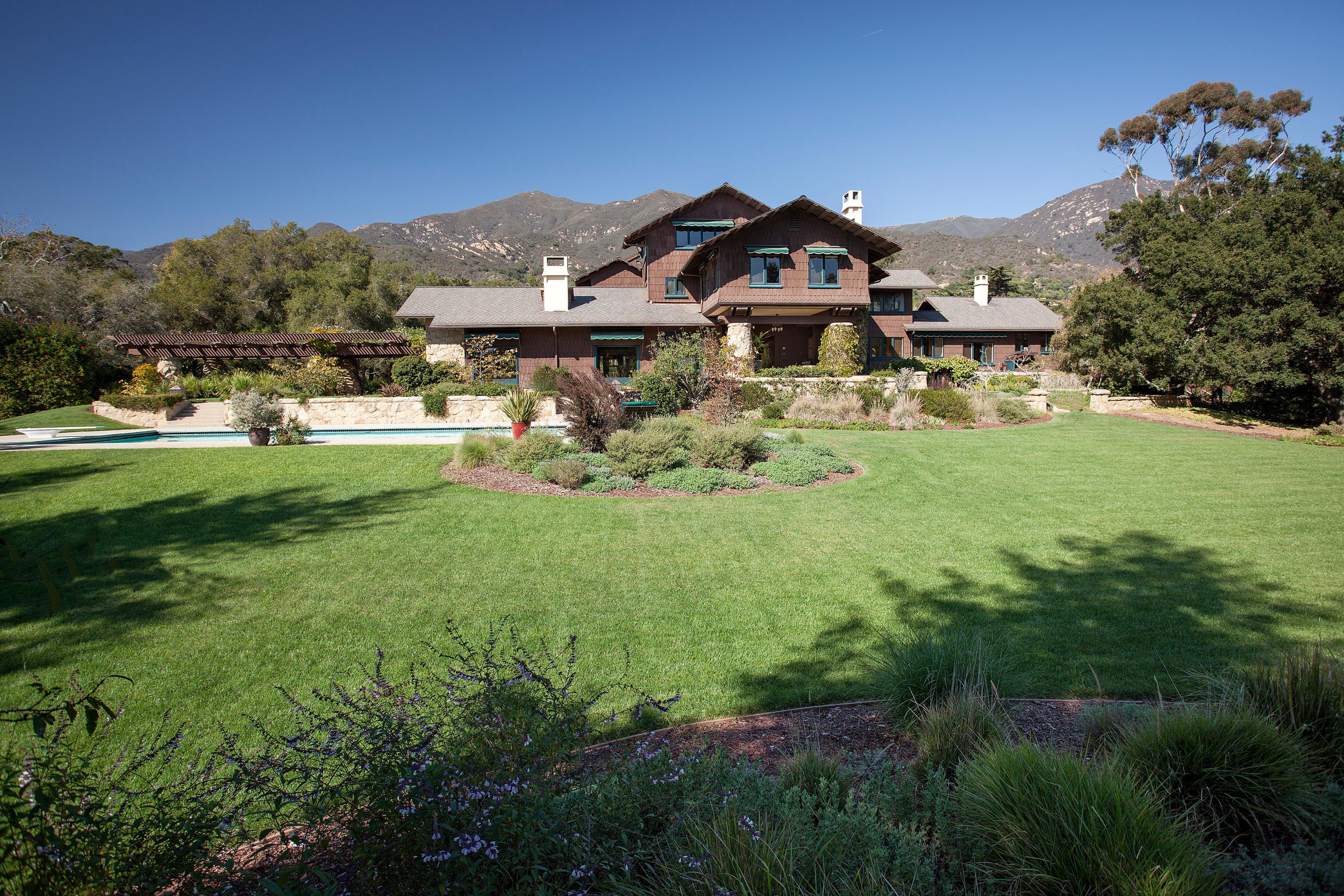 699 San Ysidro Road Montecito, CA 93108 - Photo 22 of 36 a view of a yard with a house in the background