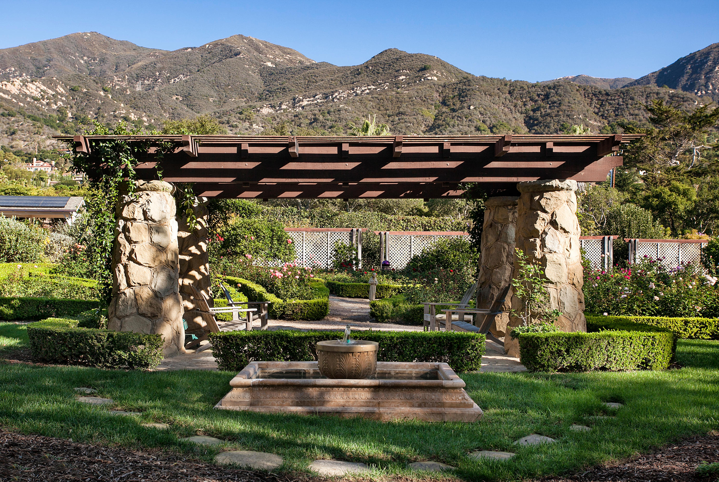 699 San Ysidro Road Montecito, CA 93108 - Photo 23 of 36 a view of a chair and table in the garden