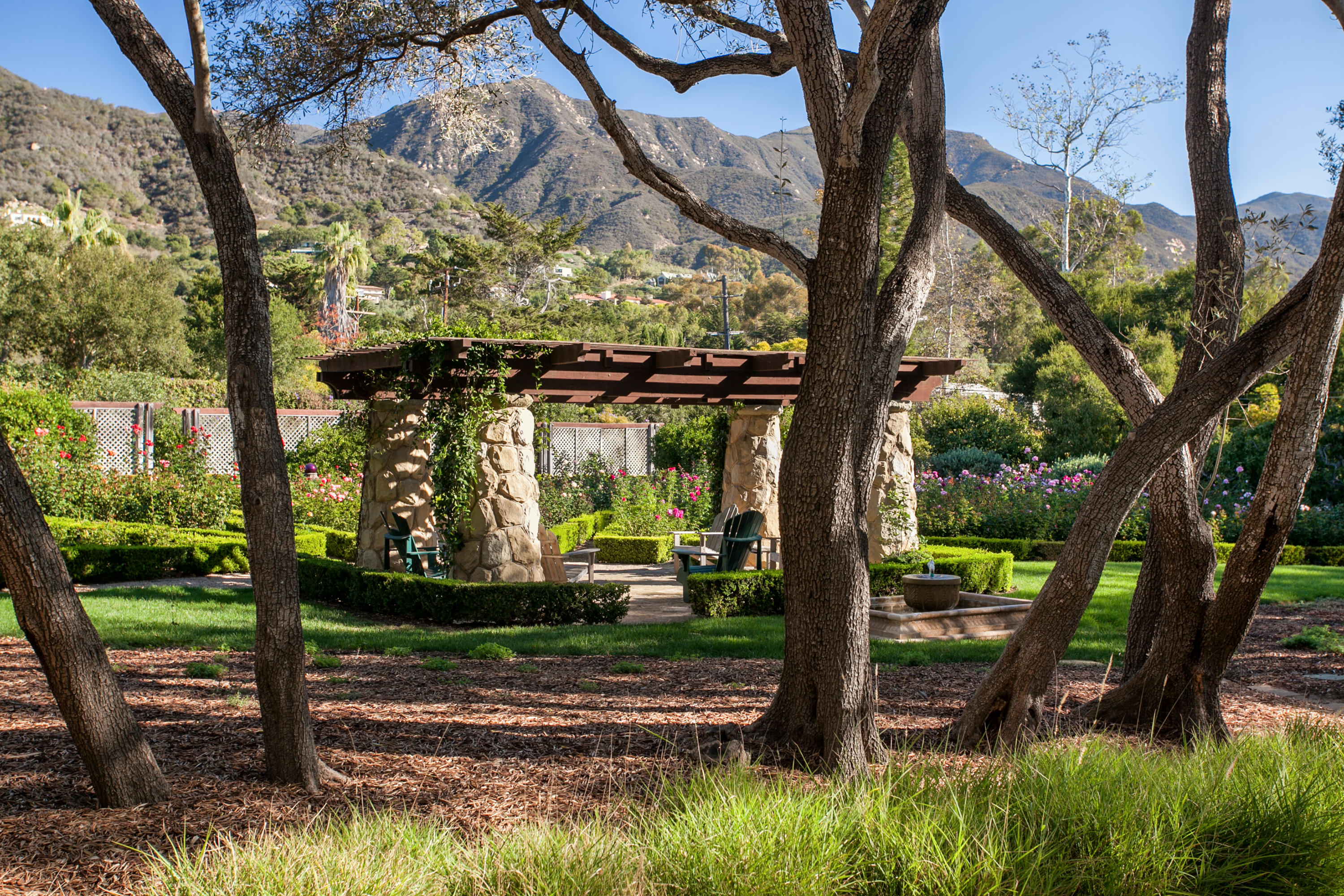 699 San Ysidro Road Montecito, CA 93108 - Photo 27 of 36 a view of a house with backyard and a tree